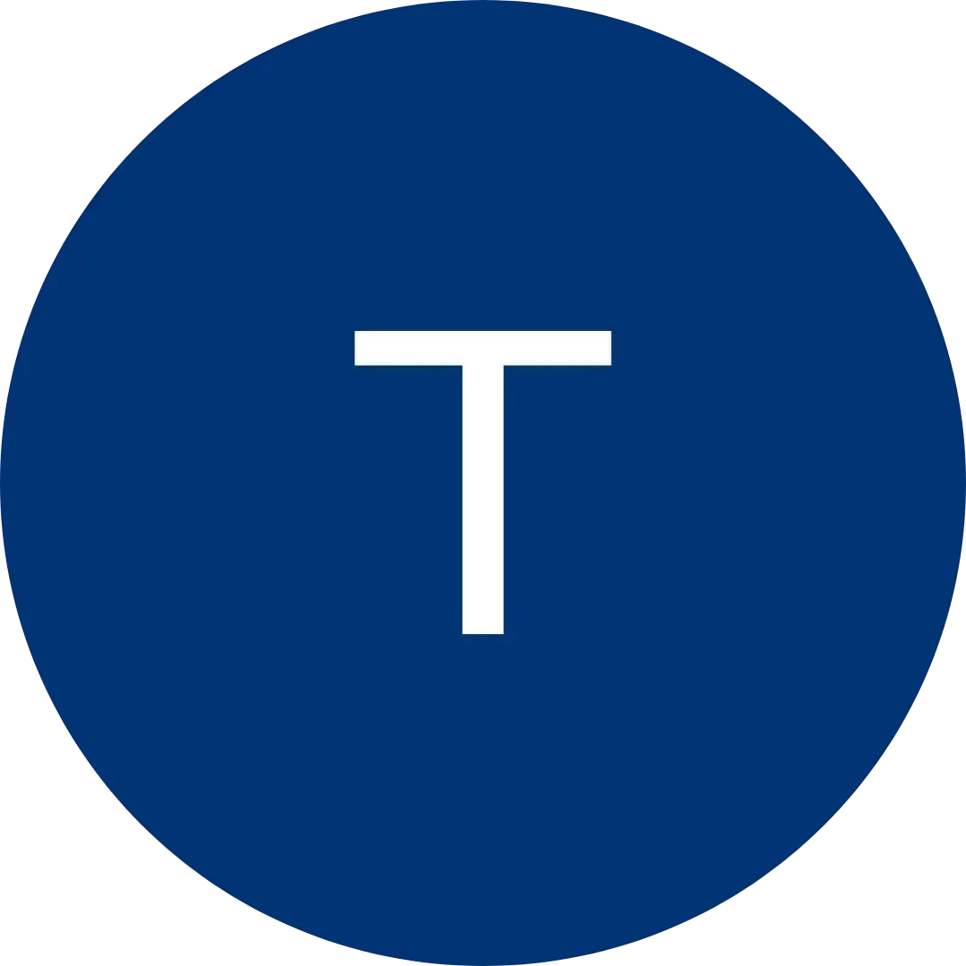 White letter T centered in a dark blue circular background.
